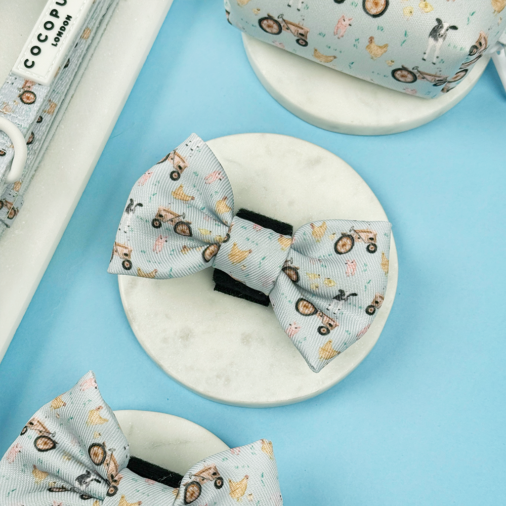 Light blue Cocopup London bow tie with playful animal and bicycle print.