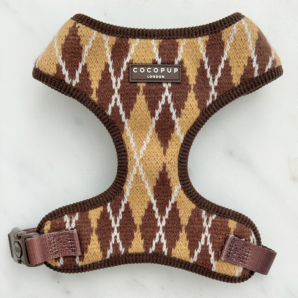 Knit dog harness with a brown, tan, and white argyle pattern.