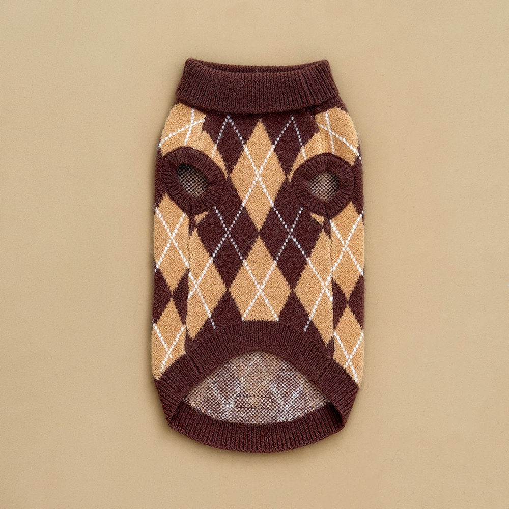 Reverse side of a dog jumper in a brown, tan, and white argyle pattern. 