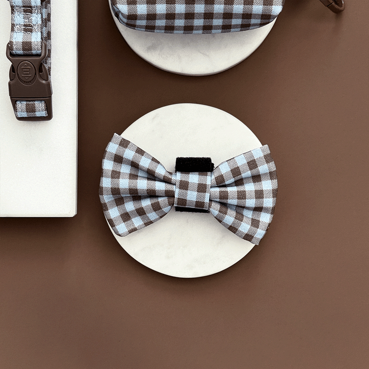 A brown and blue check print bow tie for dogs. With velcro fastening.