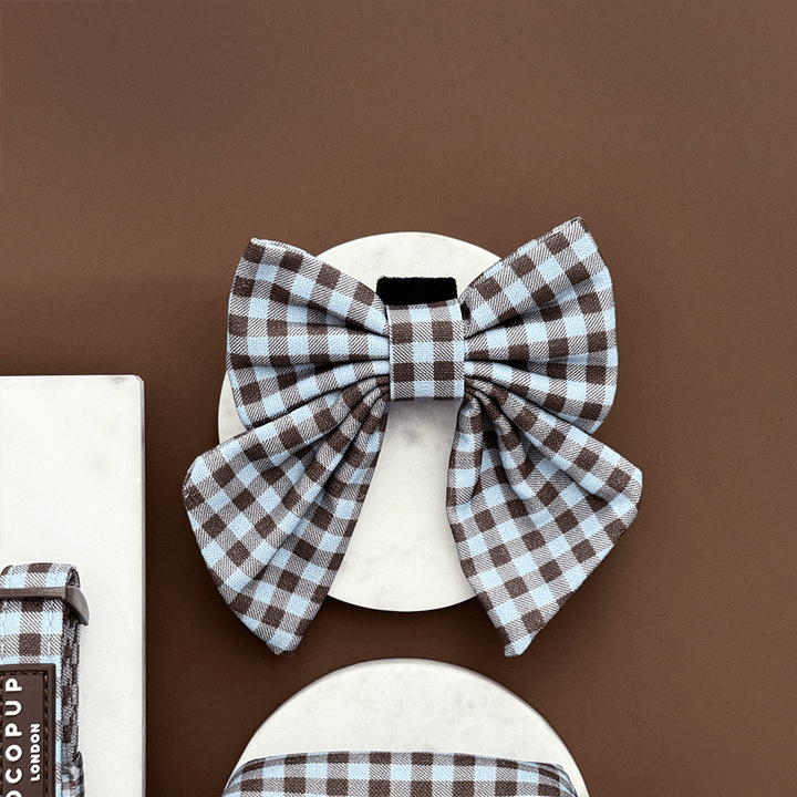 A brown and blue check print sailor bow tie for dogs. With velcro fastening.