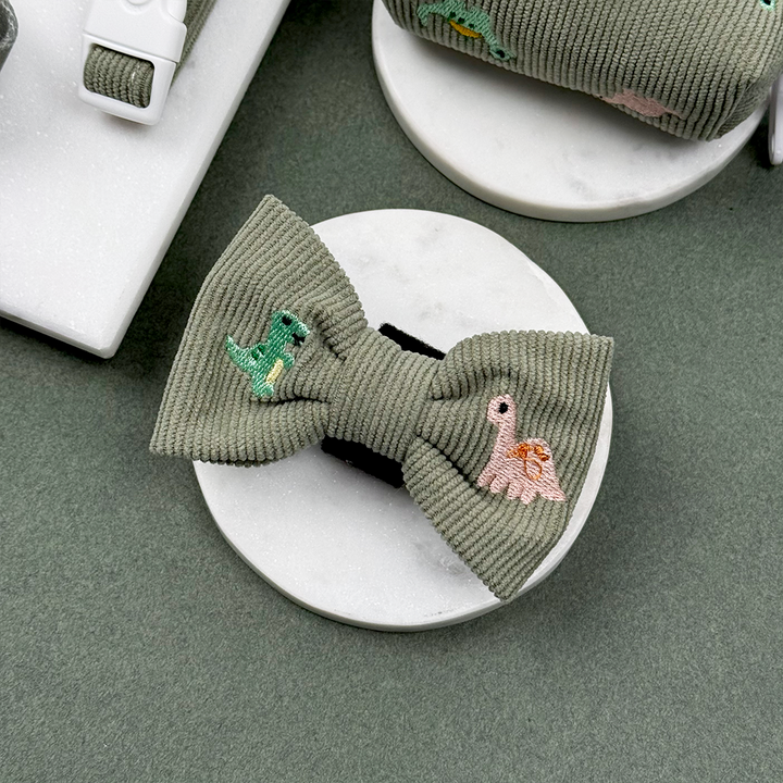 Green corduroy material Dog Bow Tie with embroidered dinosaurs. 