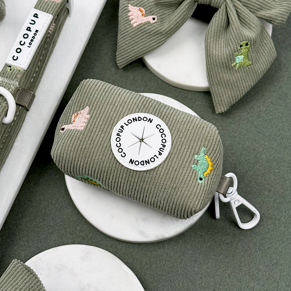 Green corduroy material Dog Poop Bag Holder with embroidered dinosaurs. 