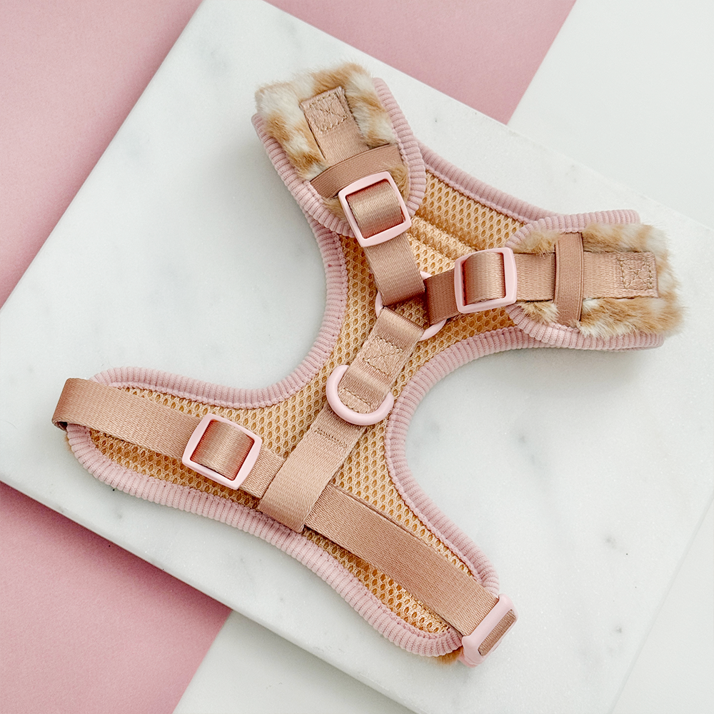 Faux fur dog harness in a beige and cream fawn pattern with pink ribbed trim and matching pink straps.