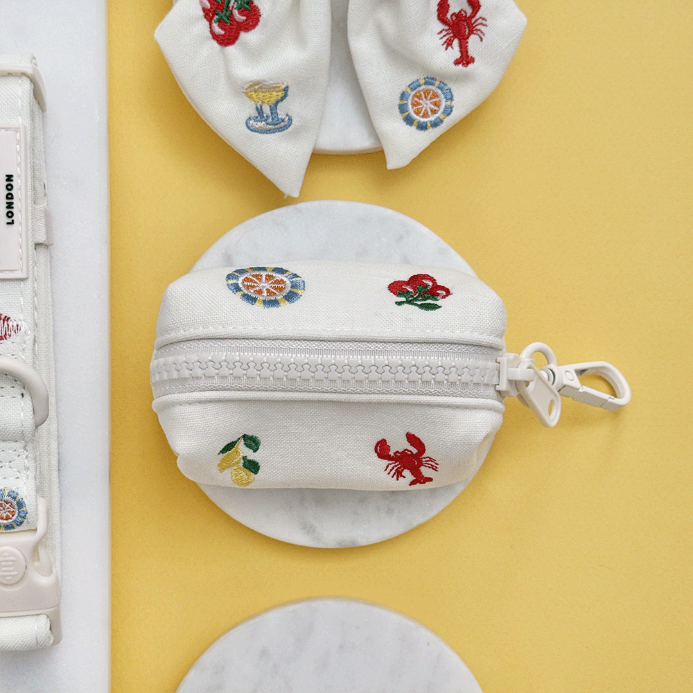White linen fabric Dog Poop Bag Holder with summer embroidered embellishments.