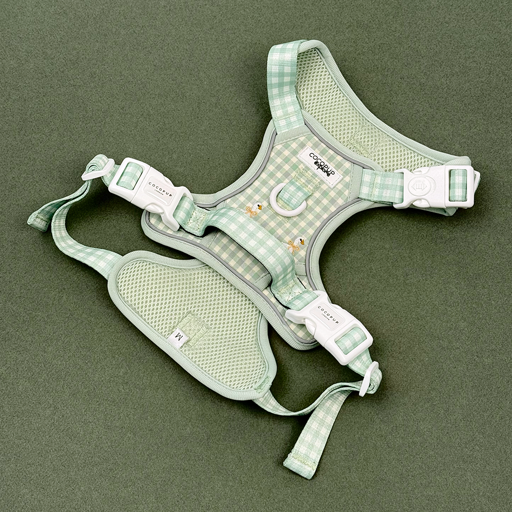 Green and white check print dog harness with embroidered geese design.