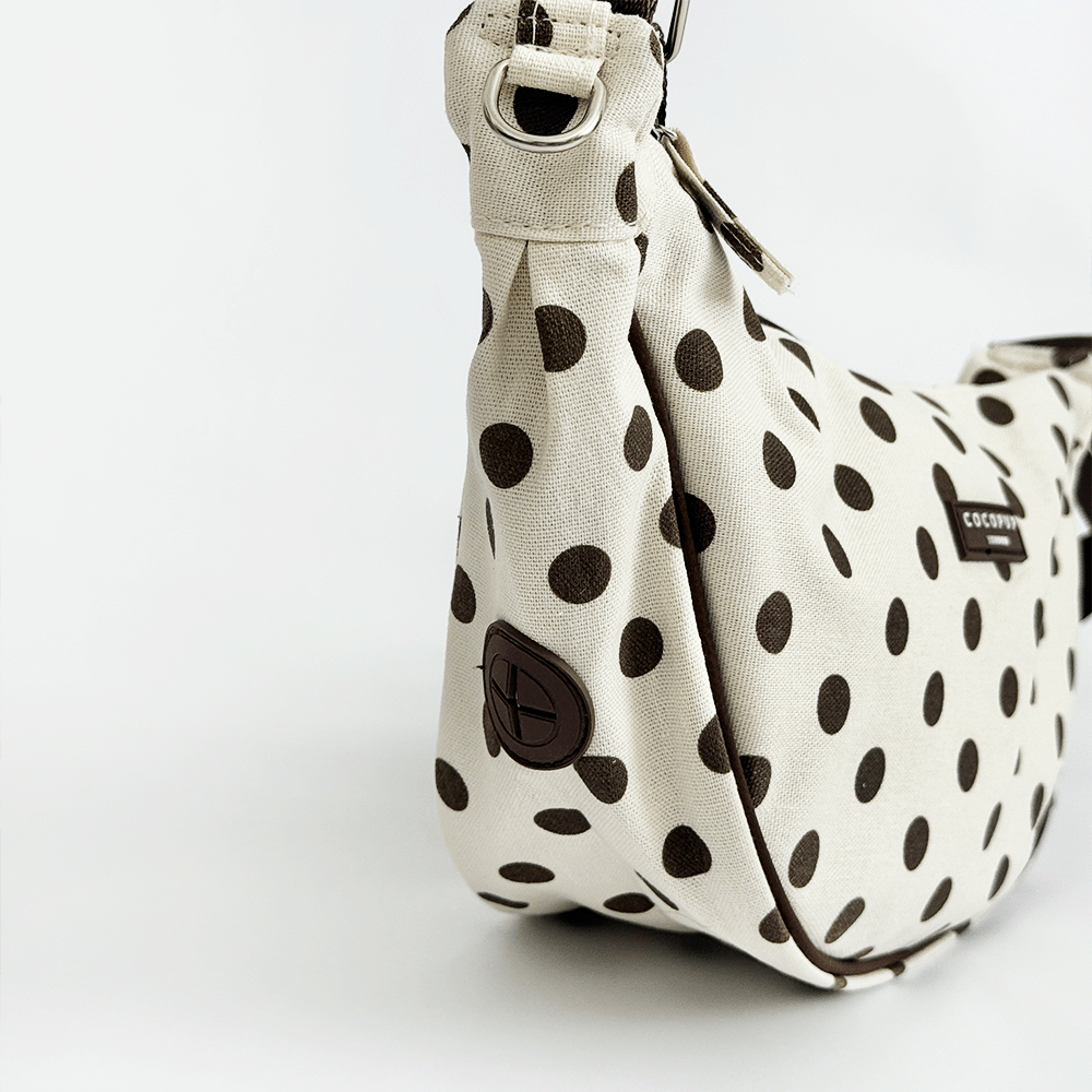 Polka dot handbag with a visible brand logo on a white background