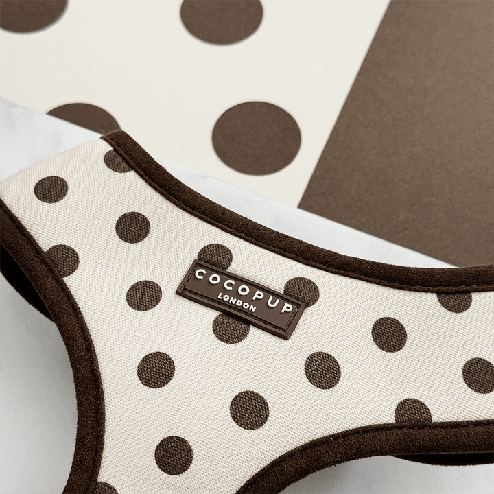 Dog harness with brown polka dots and 'Cocopup London' label on a neutral background